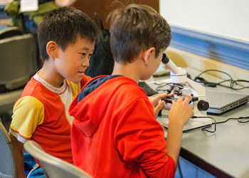 students looking through microscope