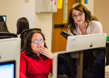 student and instructor at computer