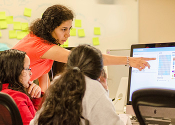 students and instructor at computer