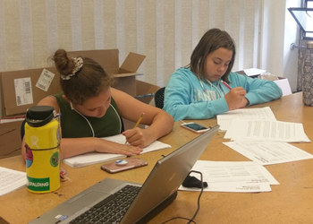 students writing at table